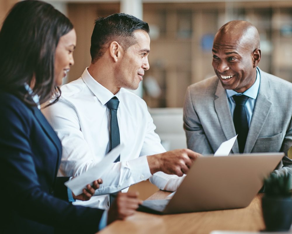 smiling-diverse-businesspeople-working-together-in-a-modern-office.jpg